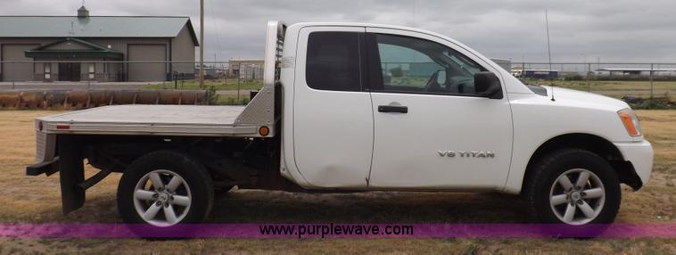 image for item J6951 2011 Nissan Titan S King Cab flatbed pickup truck