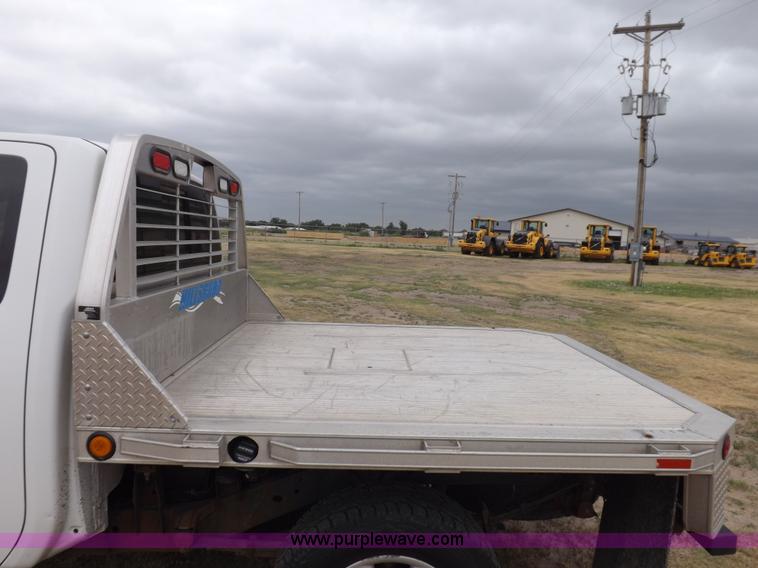 image for item J6951 2011 Nissan Titan S King Cab flatbed pickup truck