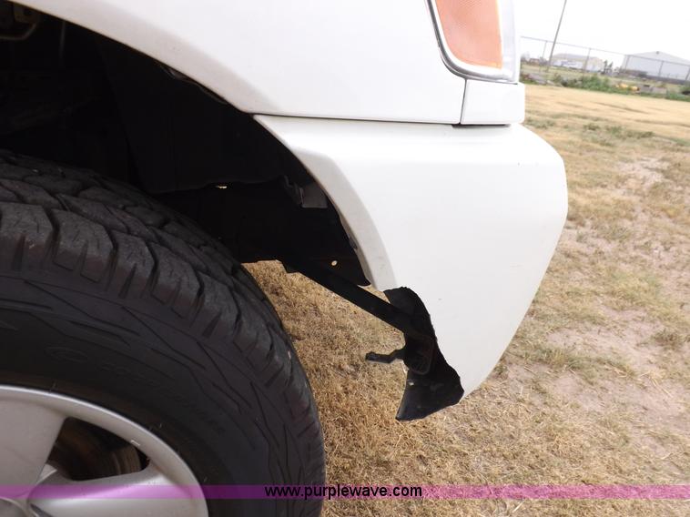 image for item J6951 2011 Nissan Titan S King Cab flatbed pickup truck