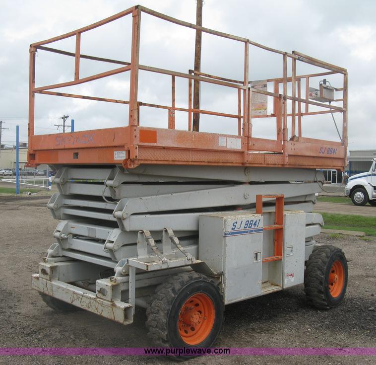 image for item K8690 1999 Sky Jack SJ8841A scissor lift