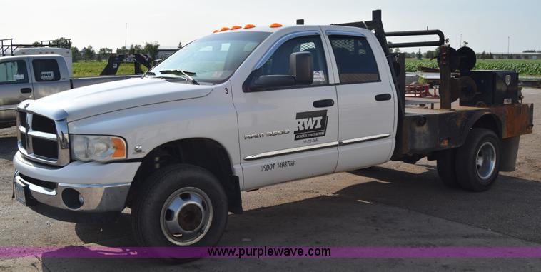 image for item L2579 2004 Dodge Ram 3500 Quad Cab flatbed pickup truck