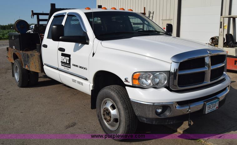 image for item L2579 2004 Dodge Ram 3500 Quad Cab flatbed pickup truck