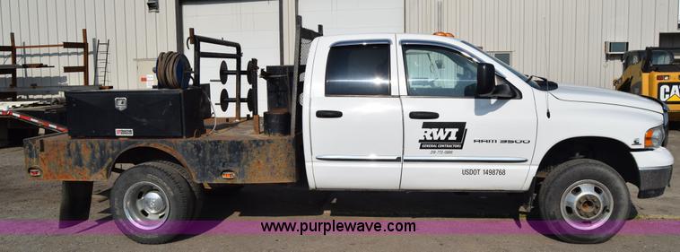 image for item L2579 2004 Dodge Ram 3500 Quad Cab flatbed pickup truck