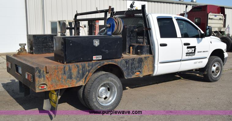 image for item L2579 2004 Dodge Ram 3500 Quad Cab flatbed pickup truck