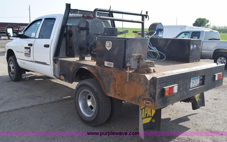 image for item L2579 2004 Dodge Ram 3500 Quad Cab flatbed pickup truck
