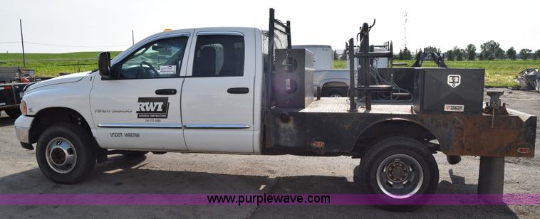 image for item L2579 2004 Dodge Ram 3500 Quad Cab flatbed pickup truck