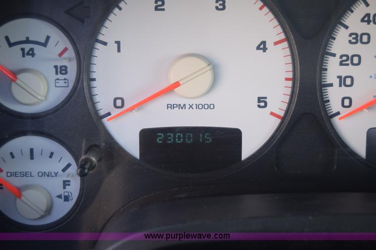 image for item L2579 2004 Dodge Ram 3500 Quad Cab flatbed pickup truck