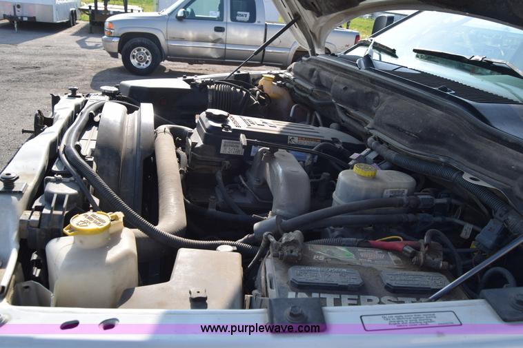 image for item L2579 2004 Dodge Ram 3500 Quad Cab flatbed pickup truck