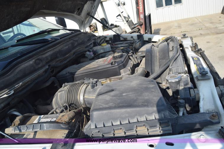 image for item L2579 2004 Dodge Ram 3500 Quad Cab flatbed pickup truck