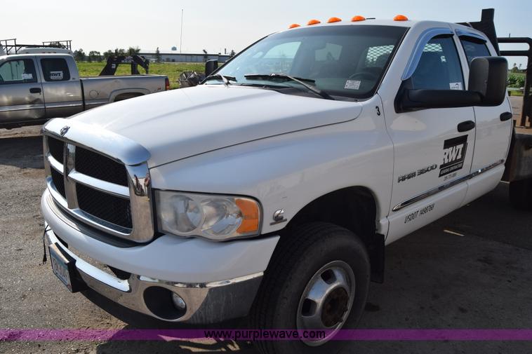 image for item L2579 2004 Dodge Ram 3500 Quad Cab flatbed pickup truck