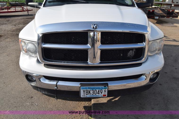 image for item L2579 2004 Dodge Ram 3500 Quad Cab flatbed pickup truck