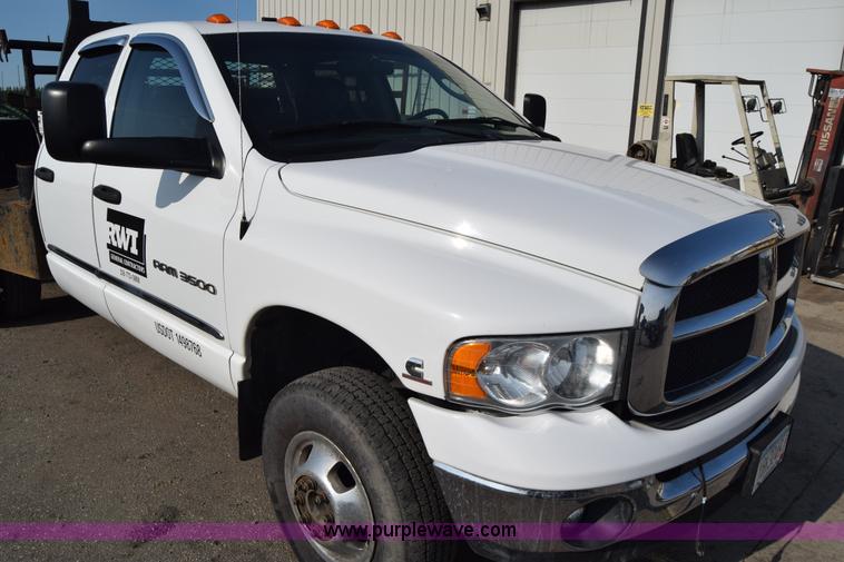 image for item L2579 2004 Dodge Ram 3500 Quad Cab flatbed pickup truck