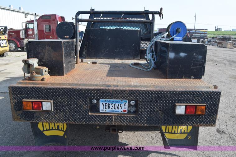 image for item L2579 2004 Dodge Ram 3500 Quad Cab flatbed pickup truck