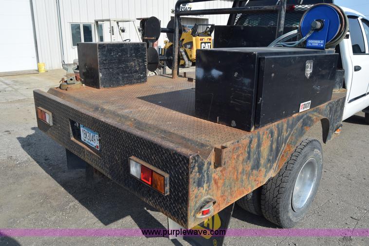 image for item L2579 2004 Dodge Ram 3500 Quad Cab flatbed pickup truck