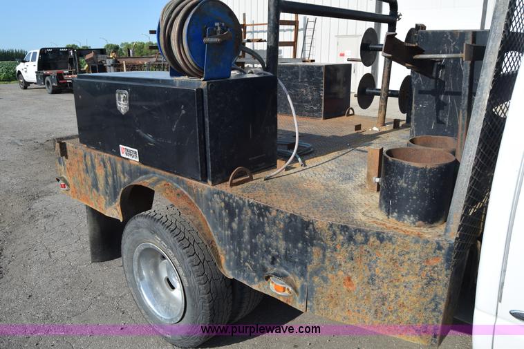 image for item L2579 2004 Dodge Ram 3500 Quad Cab flatbed pickup truck