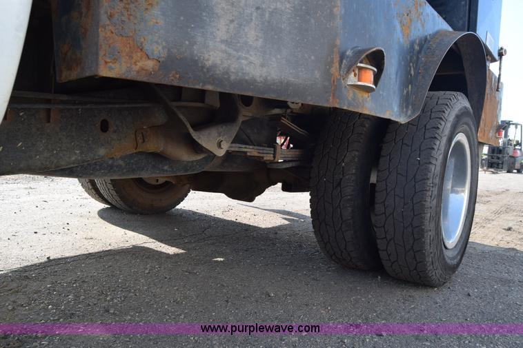 image for item L2579 2004 Dodge Ram 3500 Quad Cab flatbed pickup truck