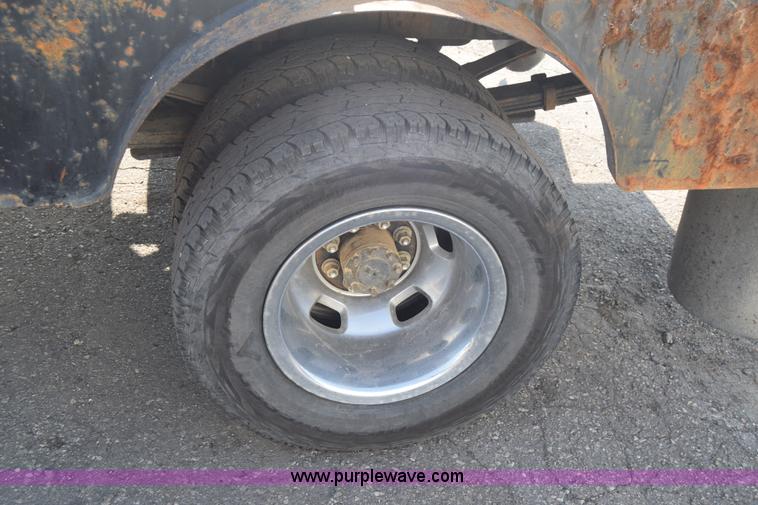 image for item L2579 2004 Dodge Ram 3500 Quad Cab flatbed pickup truck