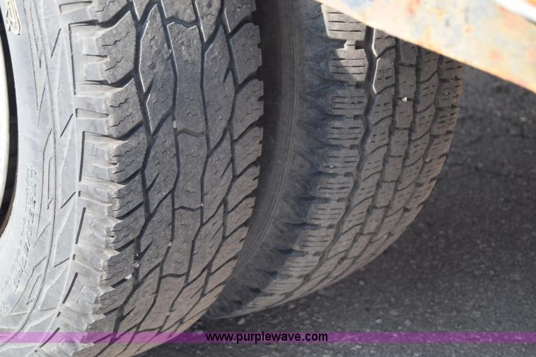 image for item L2579 2004 Dodge Ram 3500 Quad Cab flatbed pickup truck