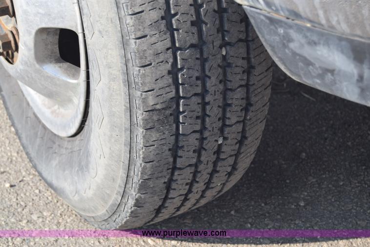 image for item L2579 2004 Dodge Ram 3500 Quad Cab flatbed pickup truck