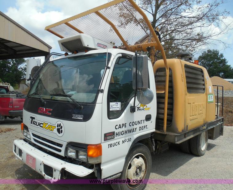 image for item K7527 2003 GMC W5500 flatbed truck with Tiger Truck Kat TRB-50C mower