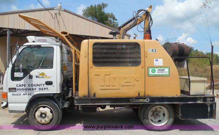 image for item K7527 2003 GMC W5500 flatbed truck with Tiger Truck Kat TRB-50C mower