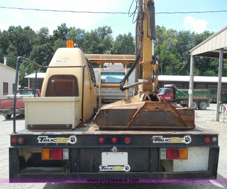 image for item K7527 2003 GMC W5500 flatbed truck with Tiger Truck Kat TRB-50C mower