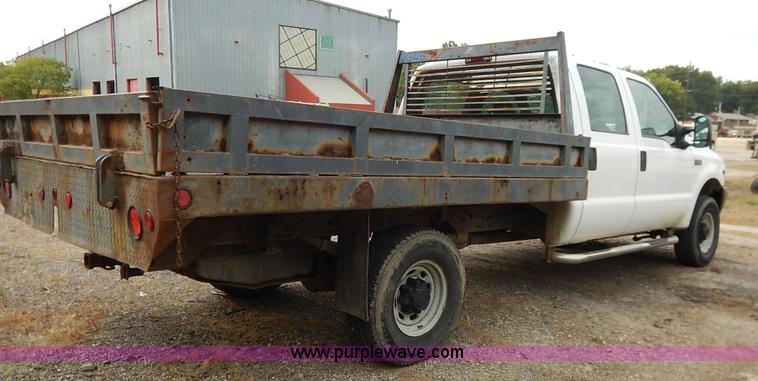 image for item J6380 2000 Ford F350 Crew Cab flatbed pickup truck