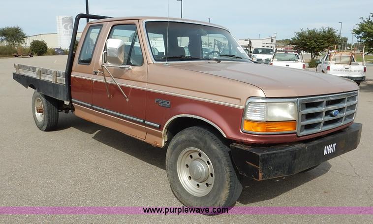 image for item K1695 1994 Ford F250 HD XLT SuperCab flatbed pickup truck