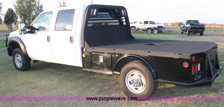 image for item J1396 2011 Ford F250 Crew Cab flatbed pickup truck