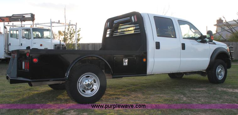 image for item J1396 2011 Ford F250 Crew Cab flatbed pickup truck