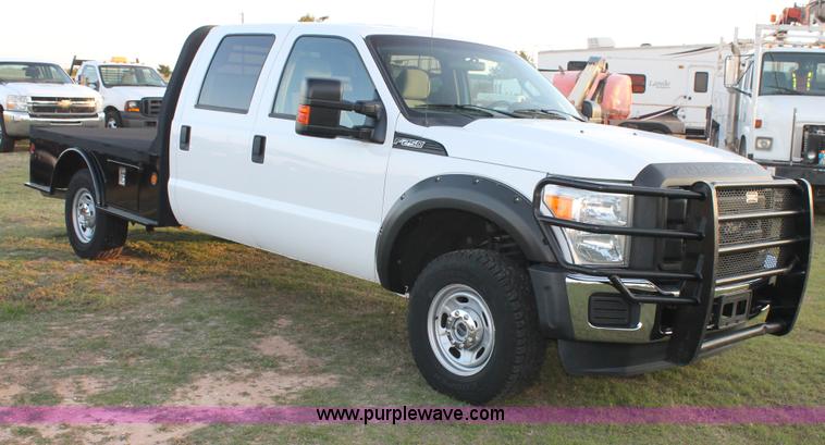 image for item J1396 2011 Ford F250 Crew Cab flatbed pickup truck