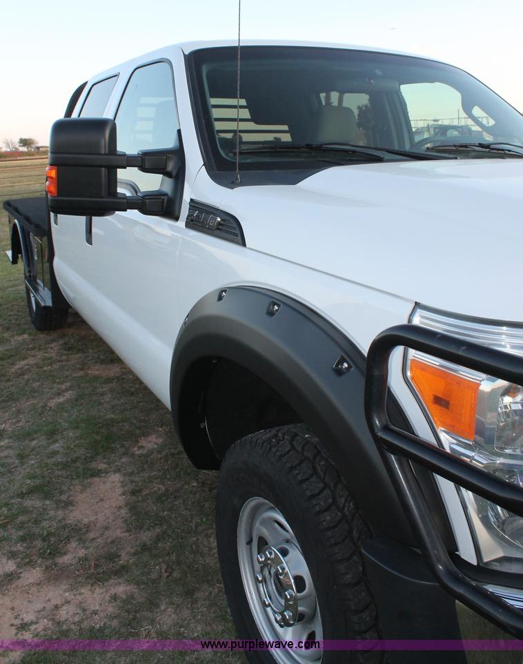 image for item J1396 2011 Ford F250 Crew Cab flatbed pickup truck