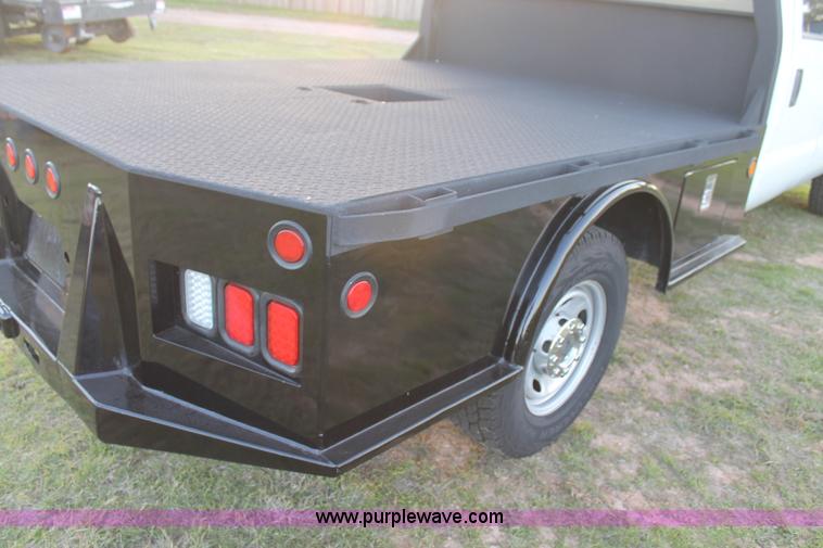 image for item J1396 2011 Ford F250 Crew Cab flatbed pickup truck