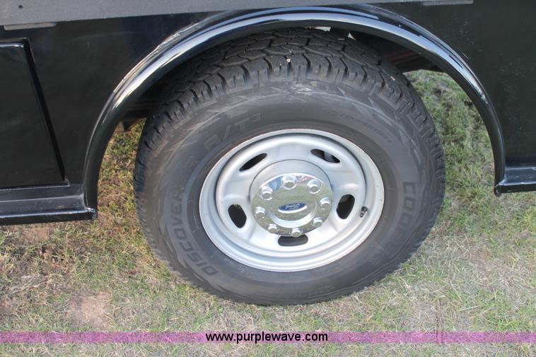 image for item J1396 2011 Ford F250 Crew Cab flatbed pickup truck