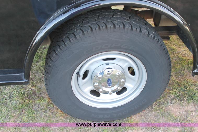 image for item J1396 2011 Ford F250 Crew Cab flatbed pickup truck