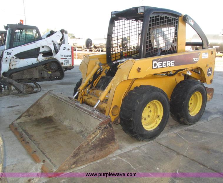 image for item H1064 2009 John Deere 320 skid steer