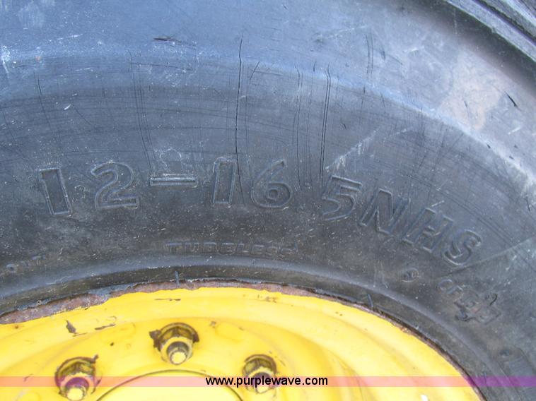 image for item H1064 2009 John Deere 320 skid steer