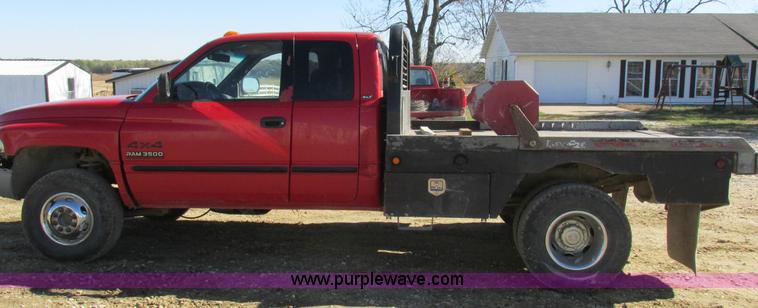 image for item K2231 2001 Dodge Ram 3500 Quad Cab flatbed pickup truck