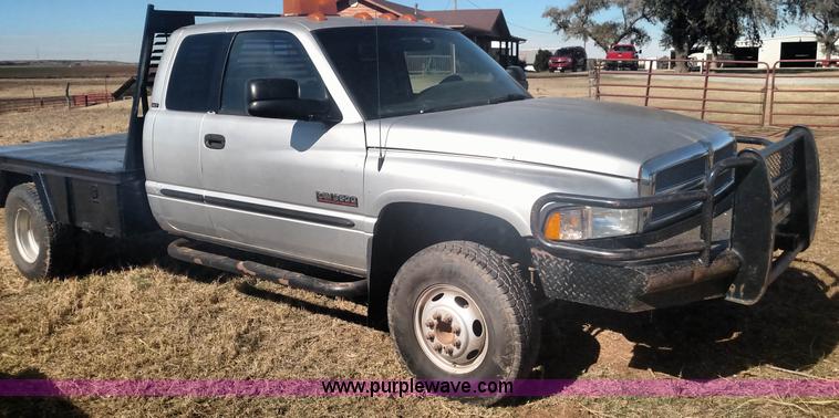 image for item L6033 2001 Dodge Ram 3500 Quad Cab flatbed pickup truck