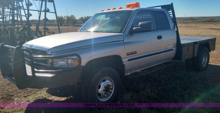 image for item L6033 2001 Dodge Ram 3500 Quad Cab flatbed pickup truck