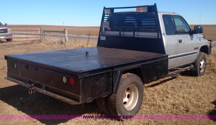 image for item L6033 2001 Dodge Ram 3500 Quad Cab flatbed pickup truck
