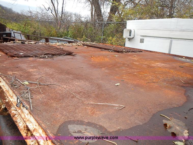 image for item J6341 1997 Freightliner FL70 rollback truck