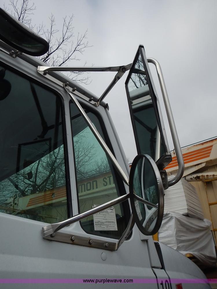 image for item J6341 1997 Freightliner FL70 rollback truck