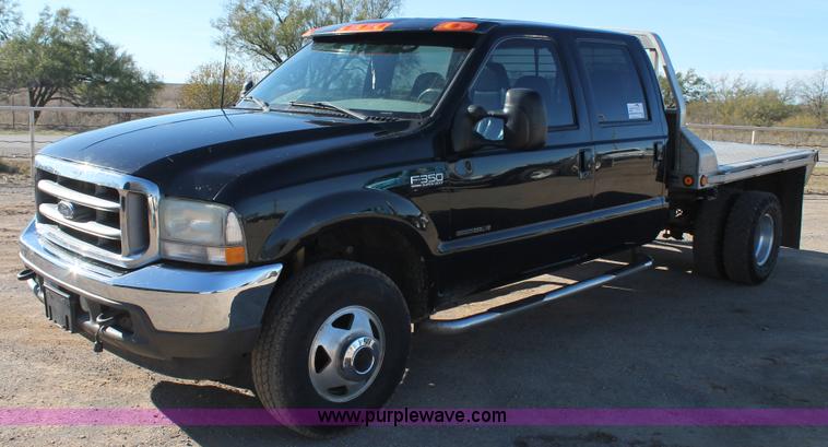 image for item L4473 2002 Ford F350 Lariat SuperCrew flatbed pickup truck