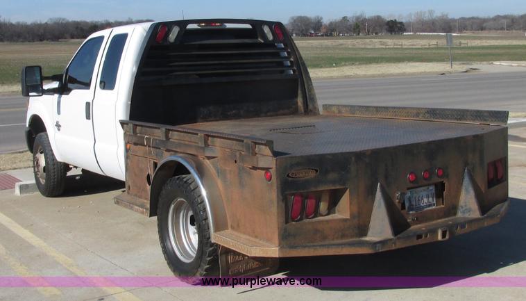 image for item J7688 2011 Ford F350 Super Duty SuperCab flatbed pickup truck
