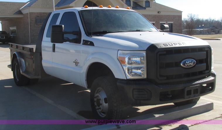 image for item J7688 2011 Ford F350 Super Duty SuperCab flatbed pickup truck