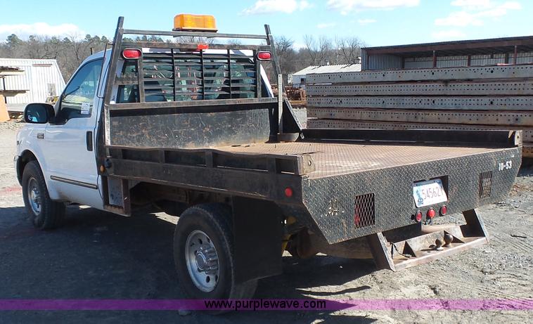 image for item J7599 2000 Ford F250 Super Duty flatbed pickup truck