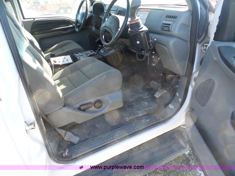 image for item AX9224 2006 Ford F550 flatbed truck with Tiger Rail Kat boom mower