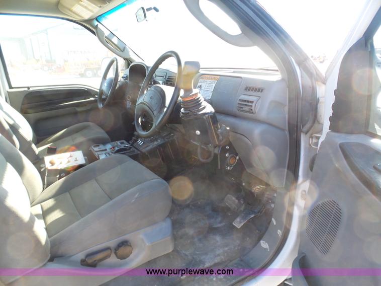 image for item AX9224 2006 Ford F550 flatbed truck with Tiger Rail Kat boom mower