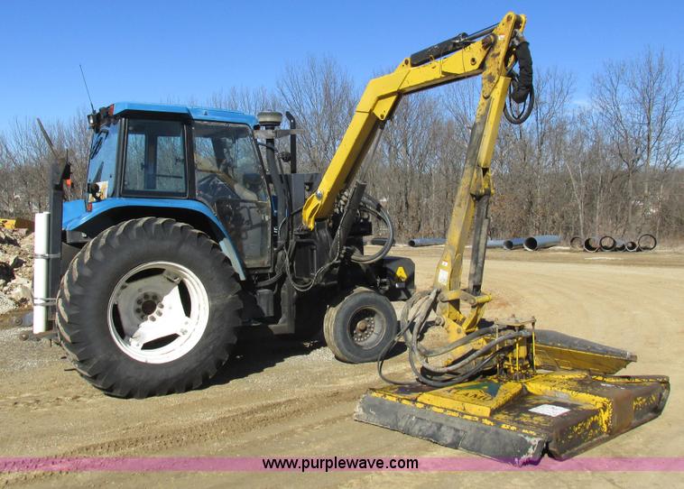 image for item L7087 1999 Ford New Holland TS110 tractor with side boom mower